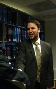 Volunteer attorney Ryan Peterson greets a clinic visitor