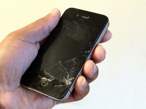 Hand Holding Cracked Smartphone